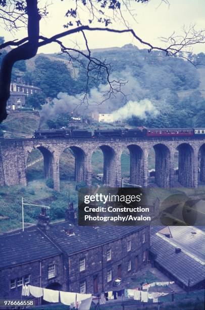 The end of steam on British Railways. A brace of ex LMS Black 5 Class 4-6-0s, Nos.44874 and 45017, storm the climb to Copey Pit summit near Todmorden...