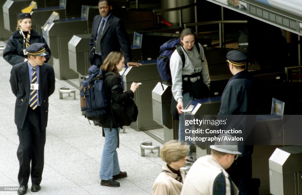 Travellers at the check-in barriers at Waterloo International station