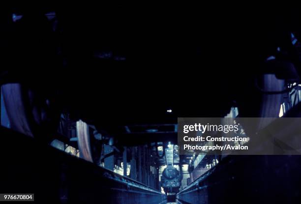 View from the inspection pit at Patricroft Depot with BR Standard 5, 4-6-0s in the background.