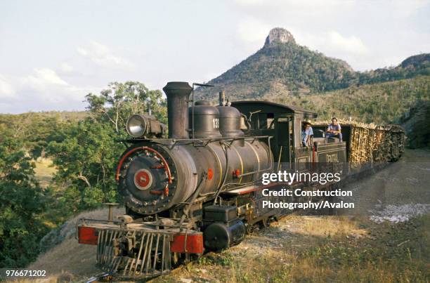 Gauge Baldwin 2-8-0 high balls a rake of loaded cane along the arroyo Blanca line at the Raphael Freyre Sugar Mill in Cuba's Holguin Province on...