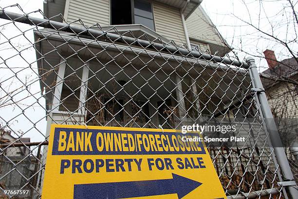 Sign is displayed in front of a foreclosed home on March 12, 2010 in Bridgeport, Connecticut. A new report by RealtyTrac Inc. Announced that the...