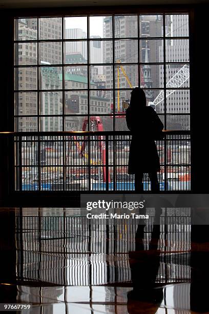 Woman looks out toward the World Trade Center site March 12, 2010 in New York City. A settlement compensating about 10,000 plaintiffs for up to...