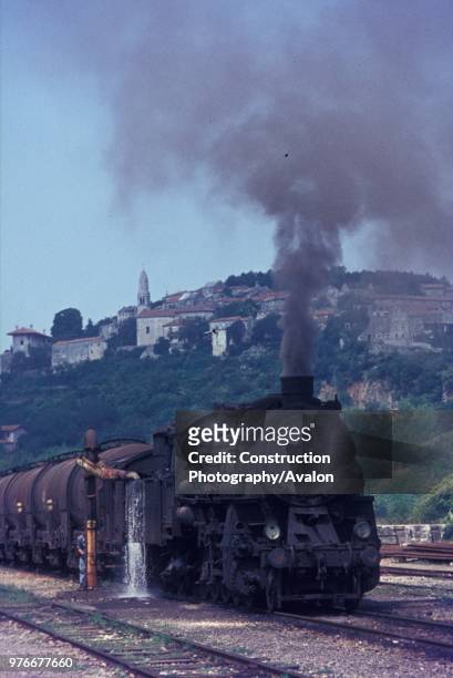 Former Prussian G12 Class 3 cylinder 2-10-0 classified 36 by Yugoslav Railways takes water at Stanjel on the line between Nova Gorica and Sezana in...