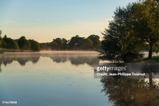 begining of a beautiful day in by a lake, france - chapeau ストックフォトと画像