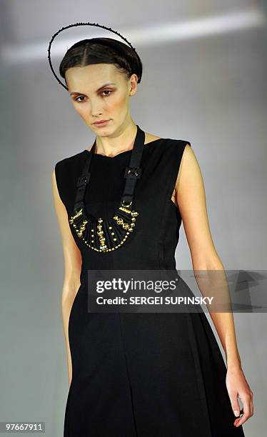 Model displays clothes from a ready to wear collection by Ukrainian fashion designer Nota Bene & Karavay during Ukrainian Fashion Week in Kiev on...