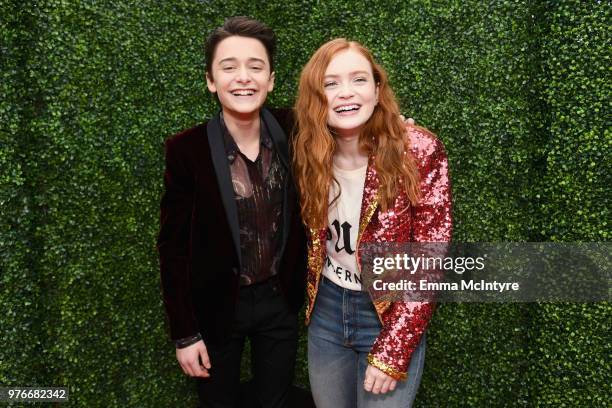 Actors Noah Schnapp and Sadie Sink attend the 2018 MTV Movie And TV Awards at Barker Hangar on June 16, 2018 in Santa Monica, California.