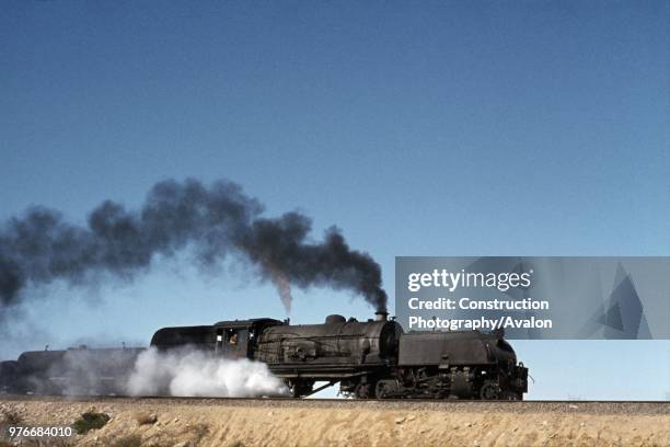 Rhodesia Railways 14 class 2-8-2 + 2-8-2 heads across the embankment at Cement in July 1973.