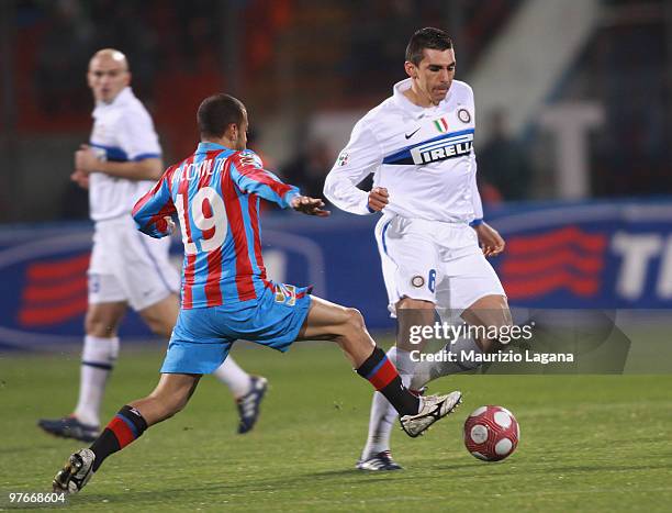 Adrian Ricchiuti of Catania Calcio battles for the ball with Ferreira da Silva Lucio of FC Internazionale Milano during the Serie A match between...