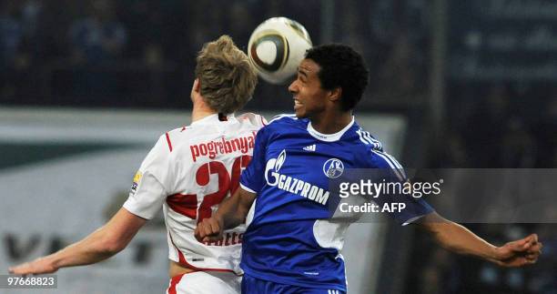 Stuttgart's Russian striker Pavel Pogrebnyak vies for the ball with Schalke's midfielder Joel Matip during the Bundesliga football match FC Schalke...