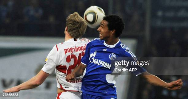 Stuttgart's Russian striker Pavel Pogrebnyak vies for the ball with Schalke's midfielder Joel Matip during the Bundesliga football match FC Schalke...