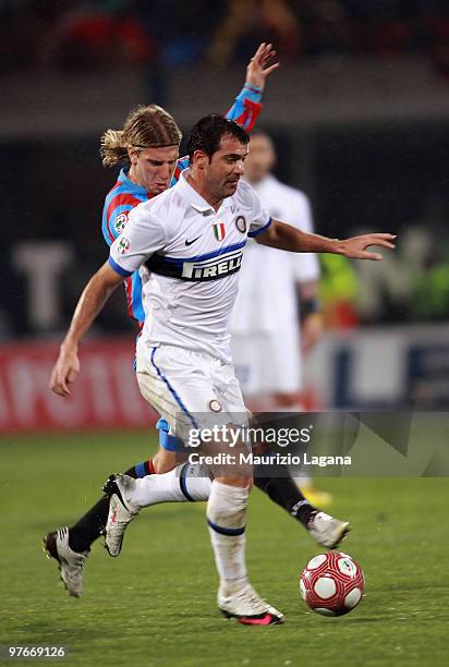 Maximiliano Maxi Lopez of Catania Calcio battles for the ball with Dejan Stankovic of FC Internazionale Milano during the Serie A match between...