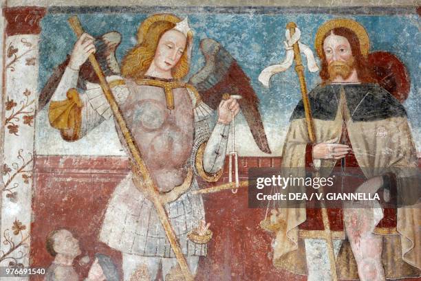 Saint Michael the Archangel and Saint Roch, fresco in the church of Saint Michael, Colarete, Lombardy, Italy, 15th century.