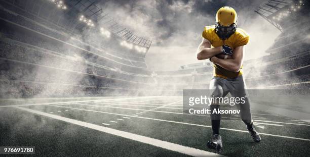 american football player in professional sport stadium - aksonov stock pictures, royalty-free photos & images