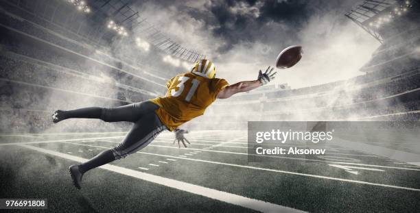 american football player in professional sport stadium - aksonov stock pictures, royalty-free photos & images