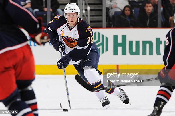 Defenseman Tobias Enstrom of the Atlanta Thrashers skates with the puck against the Columbus Blue Jackets on March 11, 2010 at Nationwide Arena in...