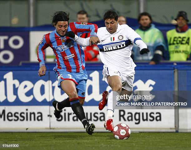 Inter Milan's Portuguese midfielder Ricardo Quaresma is challenged by Catania's Argentine defender Pablo Alvarez during their Serie A football match...