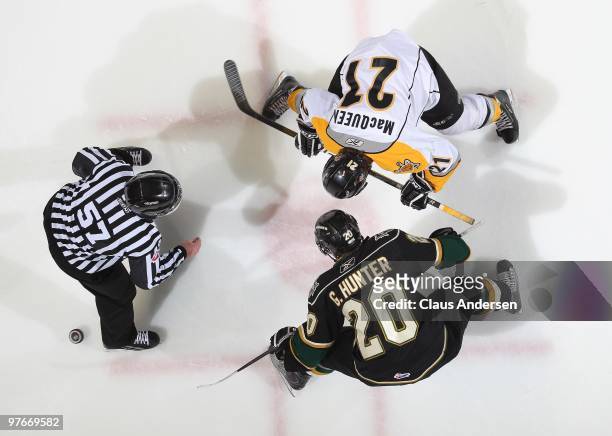 Garett Hunter of the London Knights takes a faceoff against Zack McQueen of the Sarnia Sting in a game on March 10, 2010 at the John Labatt Centre in...
