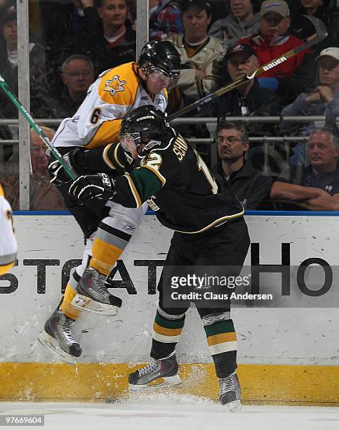 Peter Schinkelshoek of the London Knights takes Kyle Flemington of the Sarnia Sting high into the boards in a game on March 10, 2010 at the John...