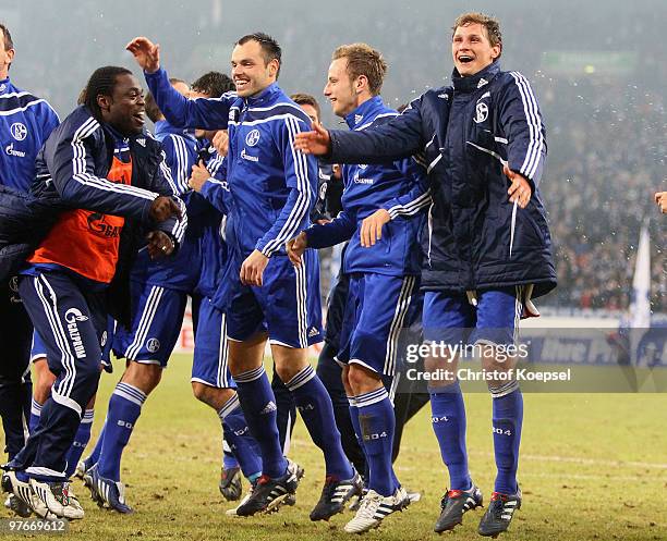 Gerald Asamoah, Heiko Westermann, Ivan Rakitic and Benedikt Hoewedes of Schalke celebrates the 2:1 victory after the Bundesliga match between FC...