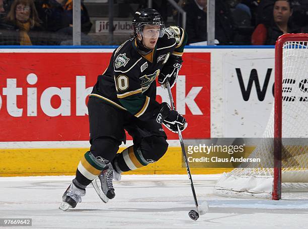 Steven Tarasuk of the London Knights skates with the puck in a game against the Sarnia Sting on March 10, 2010 at the John Labatt Centre in London,...
