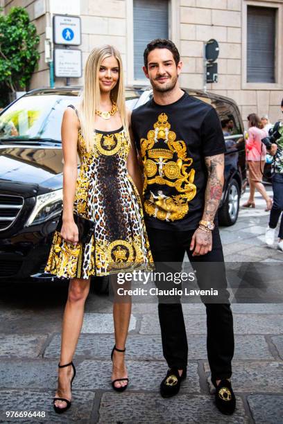 Alexandre Pato, wearing Versace t shirt and Danielle Knudson, wearing Versace dress, are seen in the streets of Milan before the Versace show, during...