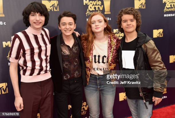 Actors Finn Wolfhard, Noah Schnapp, Sadie Sink, and Gaten Matarazzo attend the 2018 MTV Movie And TV Awards at Barker Hangar on June 16, 2018 in...