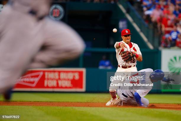 Kolten Wong of the St. Louis Cardinals attempts to turn a double play over Kris Bryant of the Chicago Cubs in the third inning at Busch Stadium on...