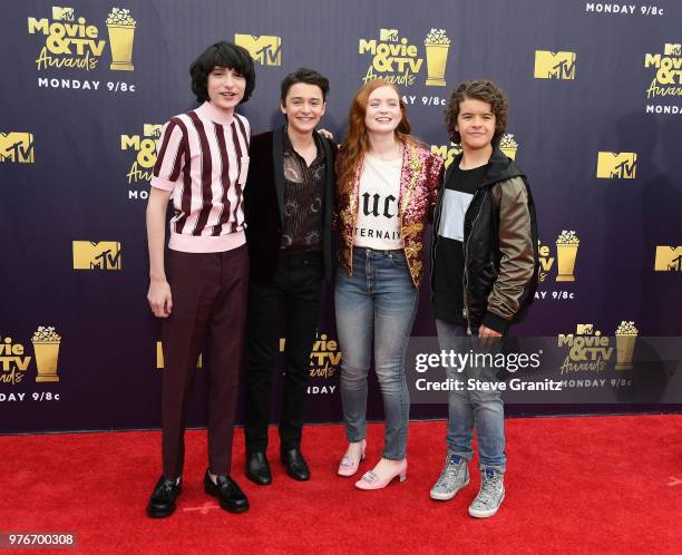 Actors Finn Wolfhard, Noah Schnapp, Sadie Sink, and Gaten Matarazzo attend the 2018 MTV Movie And TV Awards at Barker Hangar on June 16, 2018 in...