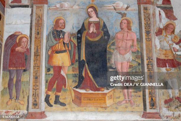 Saint Roch, Madonna and Saint Sebastian, fresco in the church of Saint Michael the Arcangel, Roncole Verdi, Emilia-Romagna, Italy, 16th century.