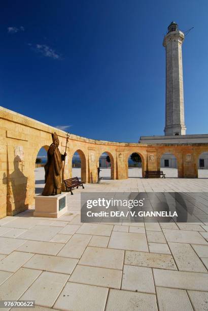 Statue of Pope Benedict XVI in the square of the Sanctuary of Santa Maria de Finibus Terrae, with the lighthouse in the centre, Santa Maria di Leuca,...