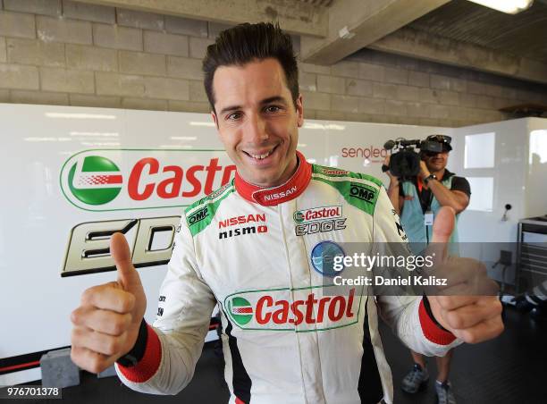 Rick Kelly driver of the Nissan Motorsport Nissan Altima celebrates after taking pole position duruing the top ten shoot out for race 16 of the...