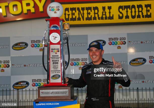 Brett Moffitt, driver of the Destiny Homes Toyota, poses with the trophy after winning the NASCAR Camping World Truck Series M&M's 200 presented by...