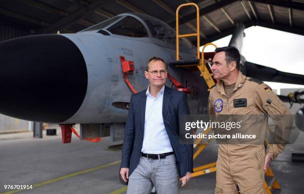 Dpatop - Governing Mayor of Berlin and President of the Bundesrat Michael Mueller and base commander Kristof Conrath inspect a German Panavia Tornado...