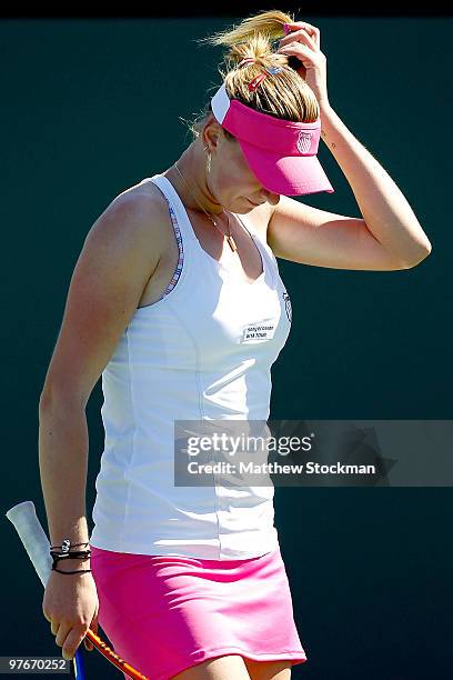 Olga Govortsova of Belarus adjusts her visor between points against Elena Dementieva of Russia during the BNP Paribas Open on March 12, 2010 in...