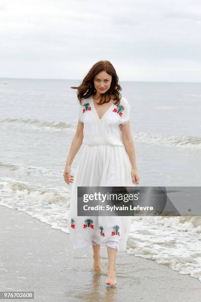 Olga Kurylenko poses for photographers on the beach of Cabourg during Film Festival on June 16, 2018 in Cabourg, France.