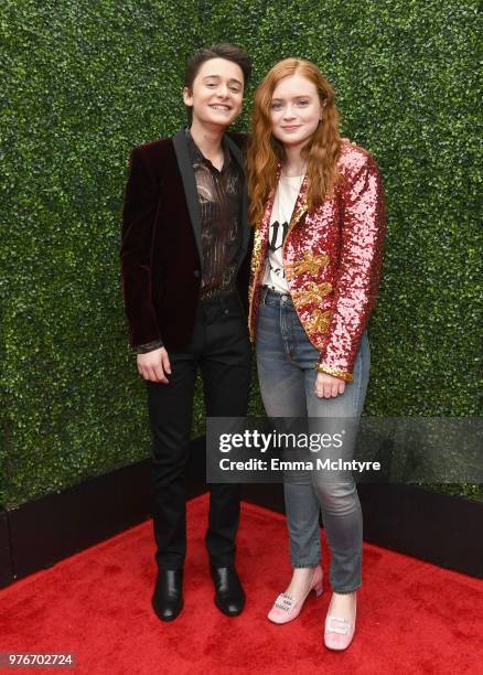 Actors Noah Schnapp and Sadie Sink attend the 2018 MTV Movie And TV Awards at Barker Hangar on June 16, 2018 in Santa Monica, California.