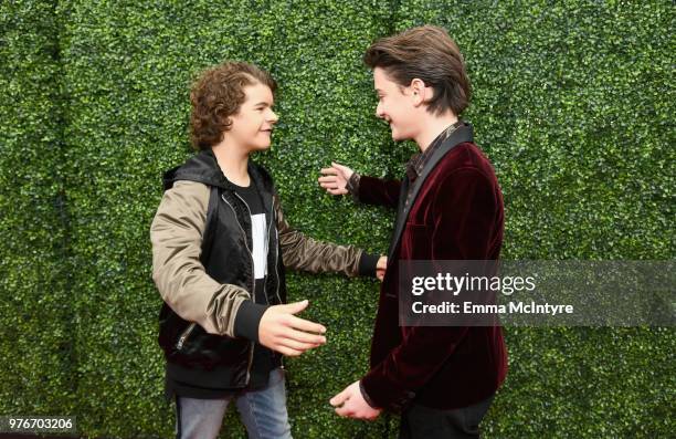 Actors Gaten Matarazzo and Noah Schnapp attends the 2018 MTV Movie And TV Awards at Barker Hangar on June 16, 2018 in Santa Monica, California.