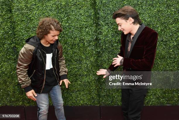 Actors Gaten Matarazzo and Noah Schnapp attends the 2018 MTV Movie And TV Awards at Barker Hangar on June 16, 2018 in Santa Monica, California.