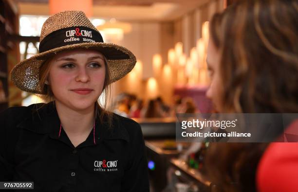 April 2018, Germany, Nienburg: Carola Kraiger , employee of the bar 'Cup&Cino' asks Rieke Mueller for 'Luisa' . If the date does not go well, to ask...