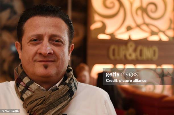 April 2018, Germany, Nienburg: Georgios Pechlevanoudis, owner of the bar 'Cup&Cino' stands at the counter of his bar. Pechlevanoudis supports the...