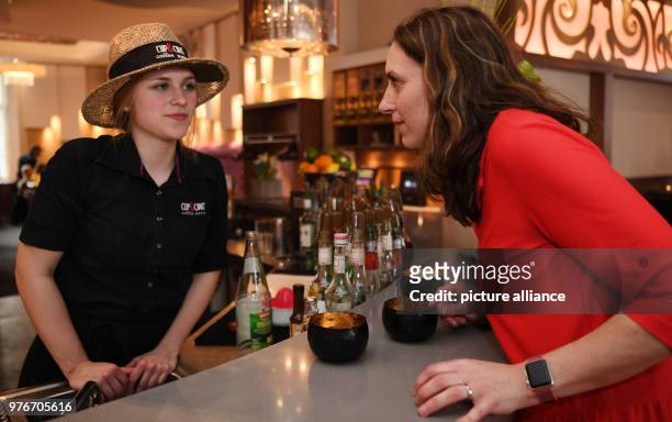 April 2018, Germany, Nienburg: Carola Kraiger , employee of the bar 'Cup&Cino' asks Rieke Mueller for 'Luisa' . If the date does not go well, to ask...