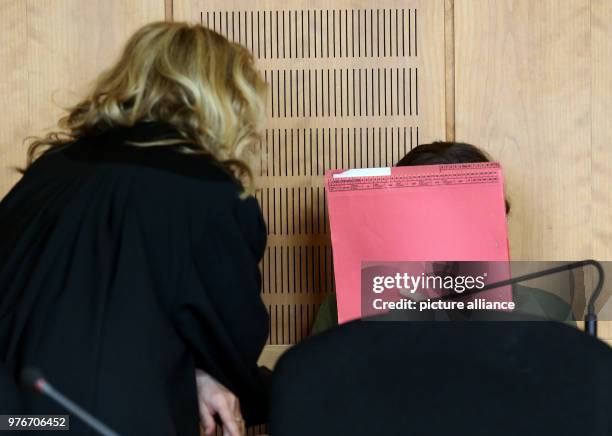 April 2018, Germany, Krefeld: A 24-year-old accused of manslaughter speaks with her lawyer Gabriele Reinartz prior to the beginning of the trial at...