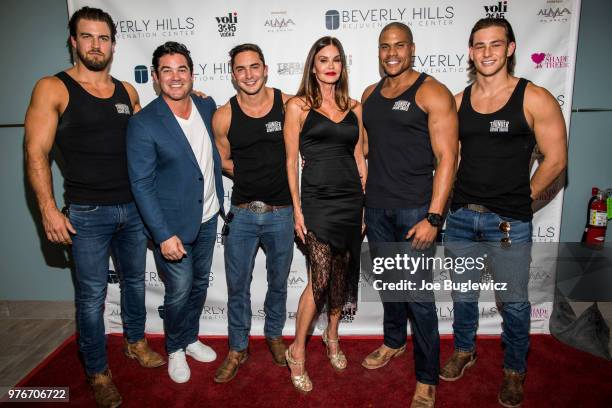 Cast members of the "Thunder From Down Under" show, pose with actor Dean Cain and model Janice Dickinson at the grand opening of the Beverly Hills...