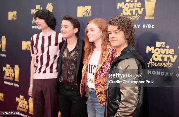 Actors Finn Wolfhard, Noah Schnapp, Sadie Sink and Gaten Matarazzo attend the 2018 MTV Movie And TV Awards at Barker Hangar on June 16, 2018 in Santa...