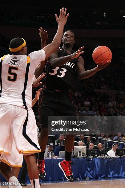 Lance Stephenson of the Cincinnati Bearcats handles the ball against Kevin Jones of the West Virginia Mountaineers during the quarterfinal of the...