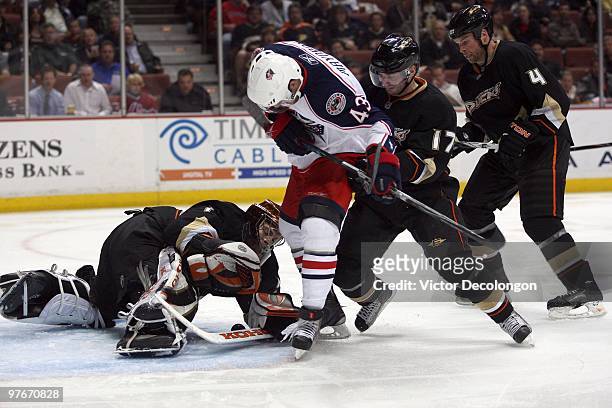 Maksim Mayorov of the Columbus Blue Jackets looks for the loose puck as goaltender Jonas Hiller, Lubomir Visnovsky and Aaron Ward of the Anaheim...