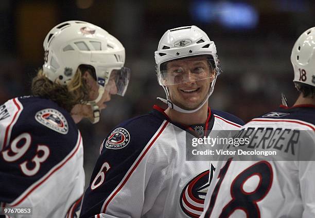 Anton Stralman of the Columbus Blue Jackets smiles while celebrating a goal by teammate Fedor Tyutin during their NHL game against the Anaheim Ducks...