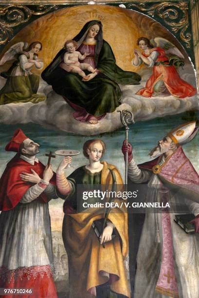 Madonna and Child, Saint Charles, Saint Lucia and Saint Augustine, painting in the Basilica of Saint Benedict, Norcia, Umbria, Italy, 17th century.