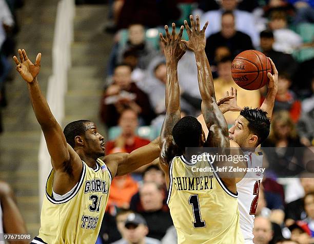 Gani Lwal and Zachery Peacock of the Georgia Tech Yellow Jackets guard Greivis Vasquez of the University of Maryland Terrapins in their quarterfinal...