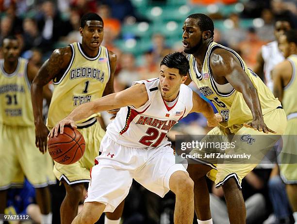 Imam Shumpert and Zachery Peacock of the Georgia Tech Yellow Jackets guard Greivis Vasquez of the University of Maryland Terrapins in their...